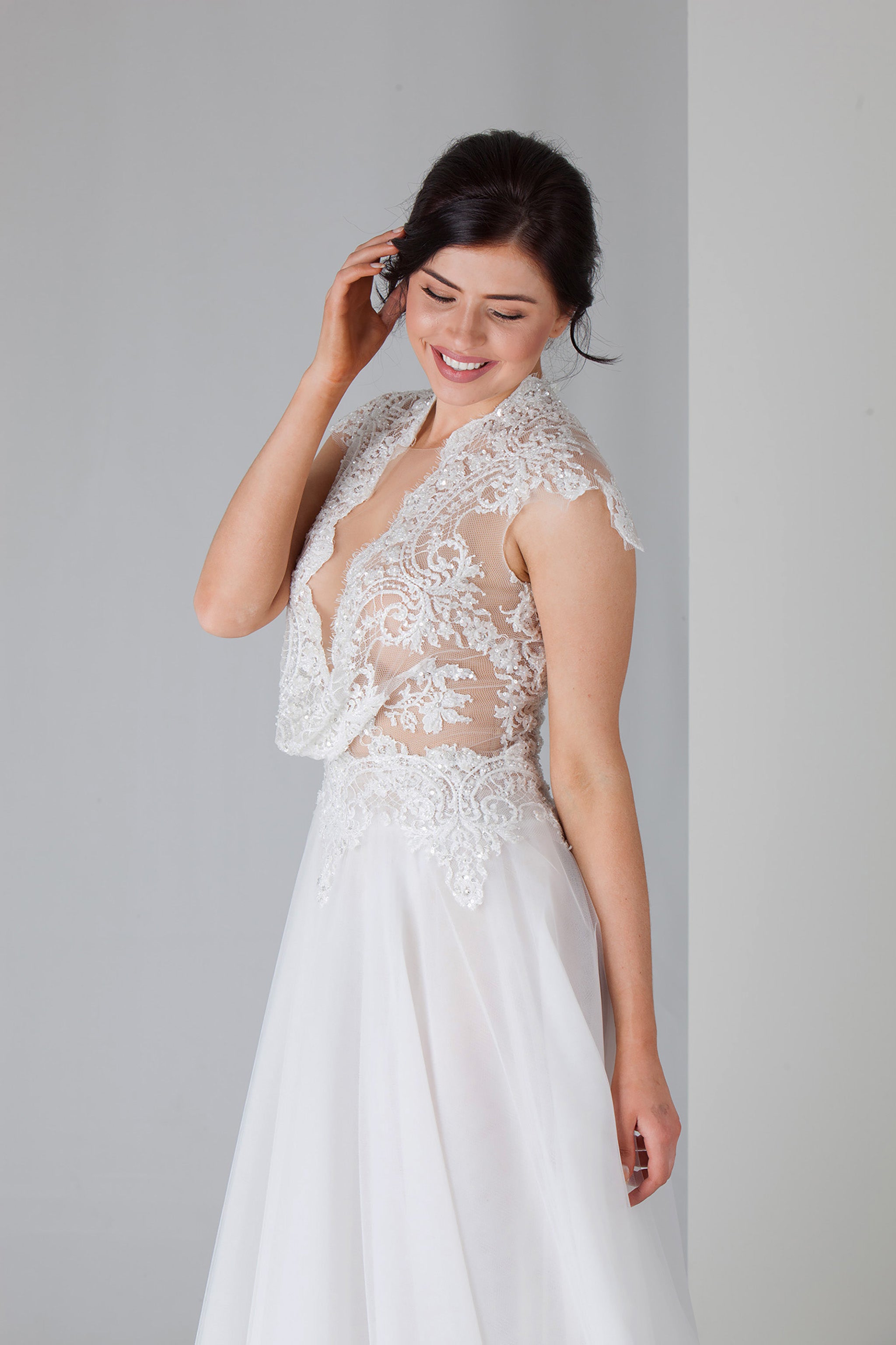 woman smiling in her beaded lace wedding dress