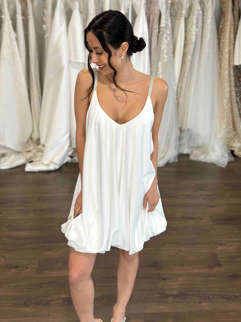 woman smiling while wearing wedding reception dress