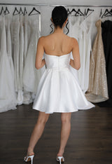 woman turning around in her short wedding reception dress