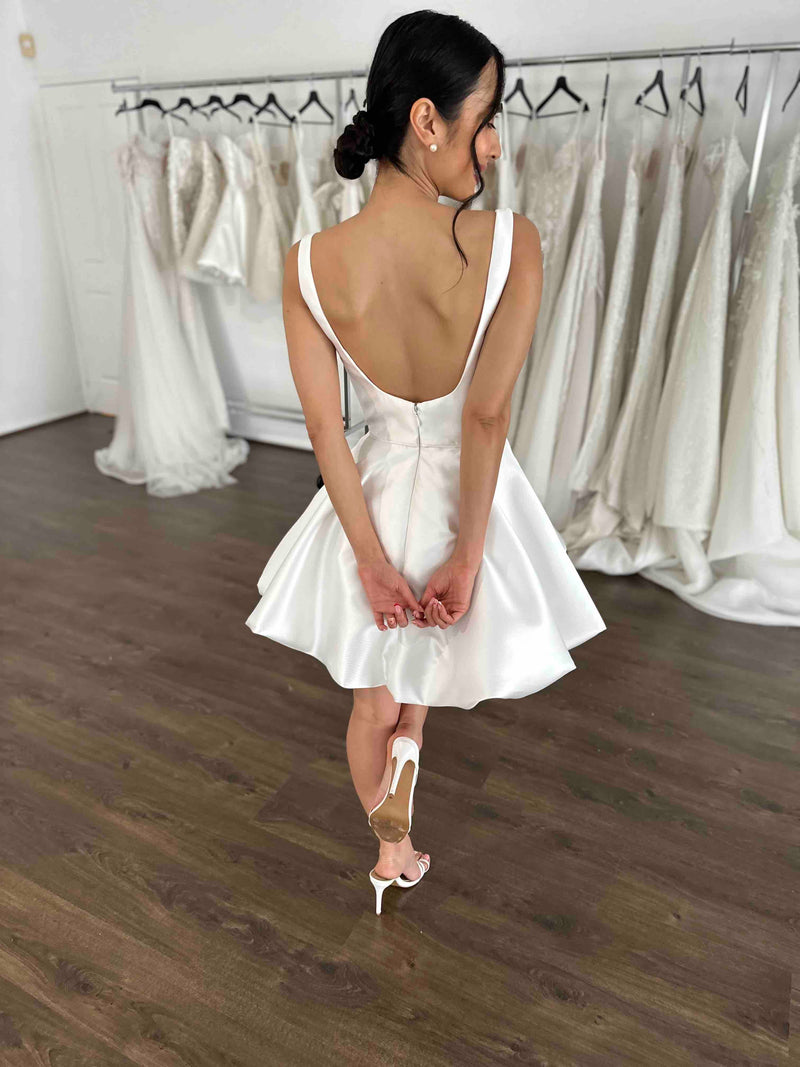 woman wearing low back bubble hem mini bridal second dress