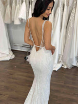 bride in her beaded wedding gown with straps and low back