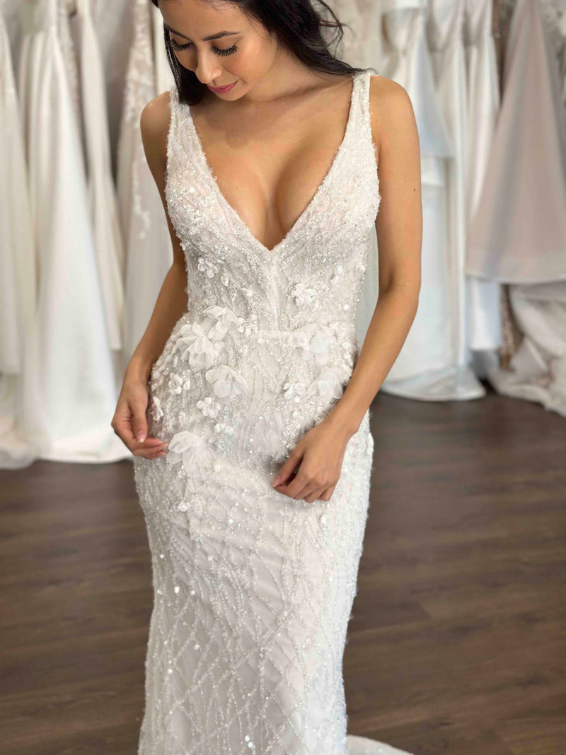 bride posing in her lace beaded wedding dress