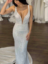 bride wearing beaded lace wedding dress with plunging v-neckline and dramatic train