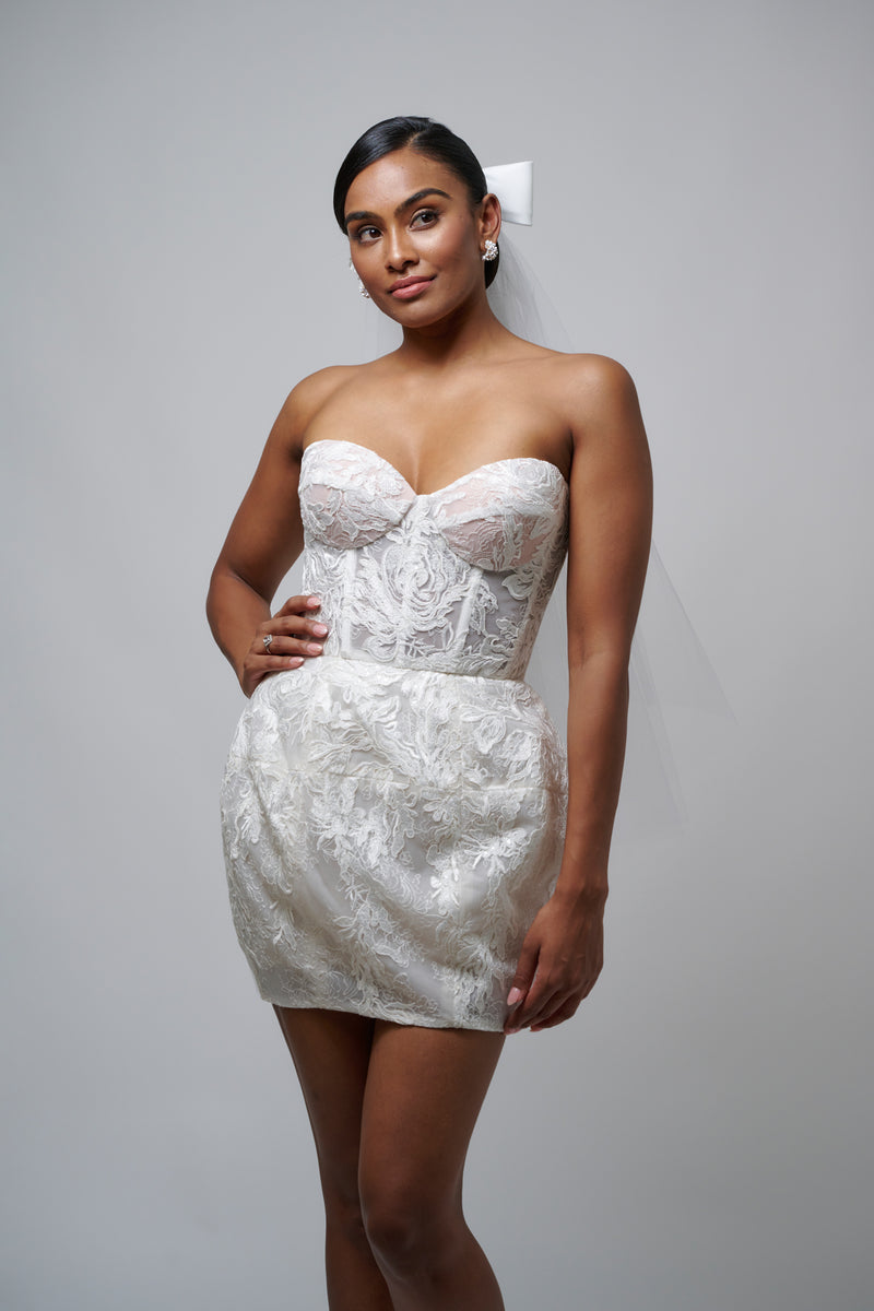 bride wearing floral lace corseted bridal mini