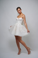 bride wearing lace mini reception dress with corset top