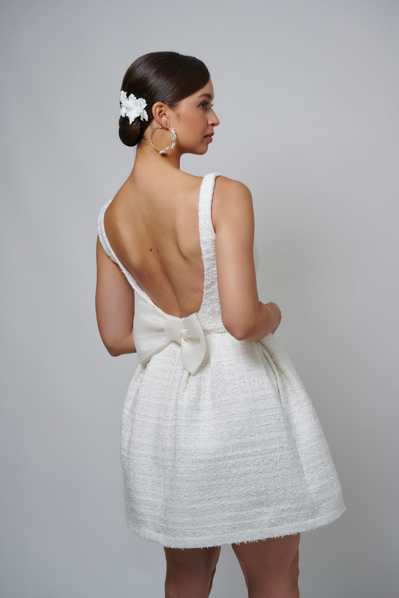 bride wearing mini dress with bow on back
