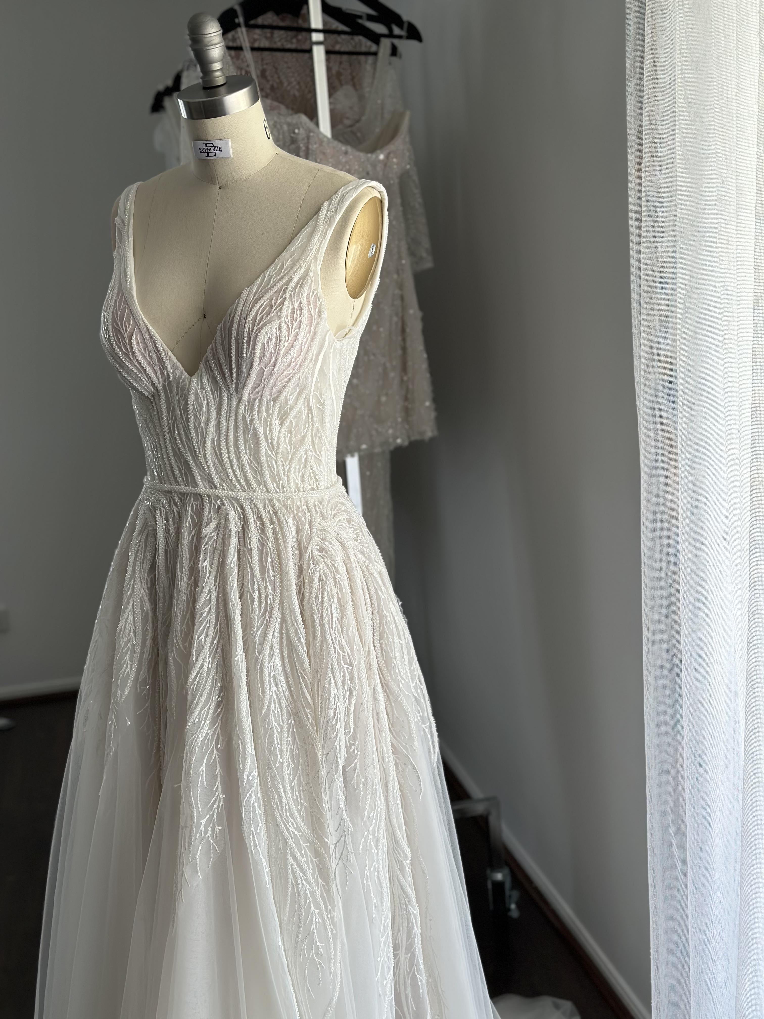 lace wedding dress on mannequin in showroom