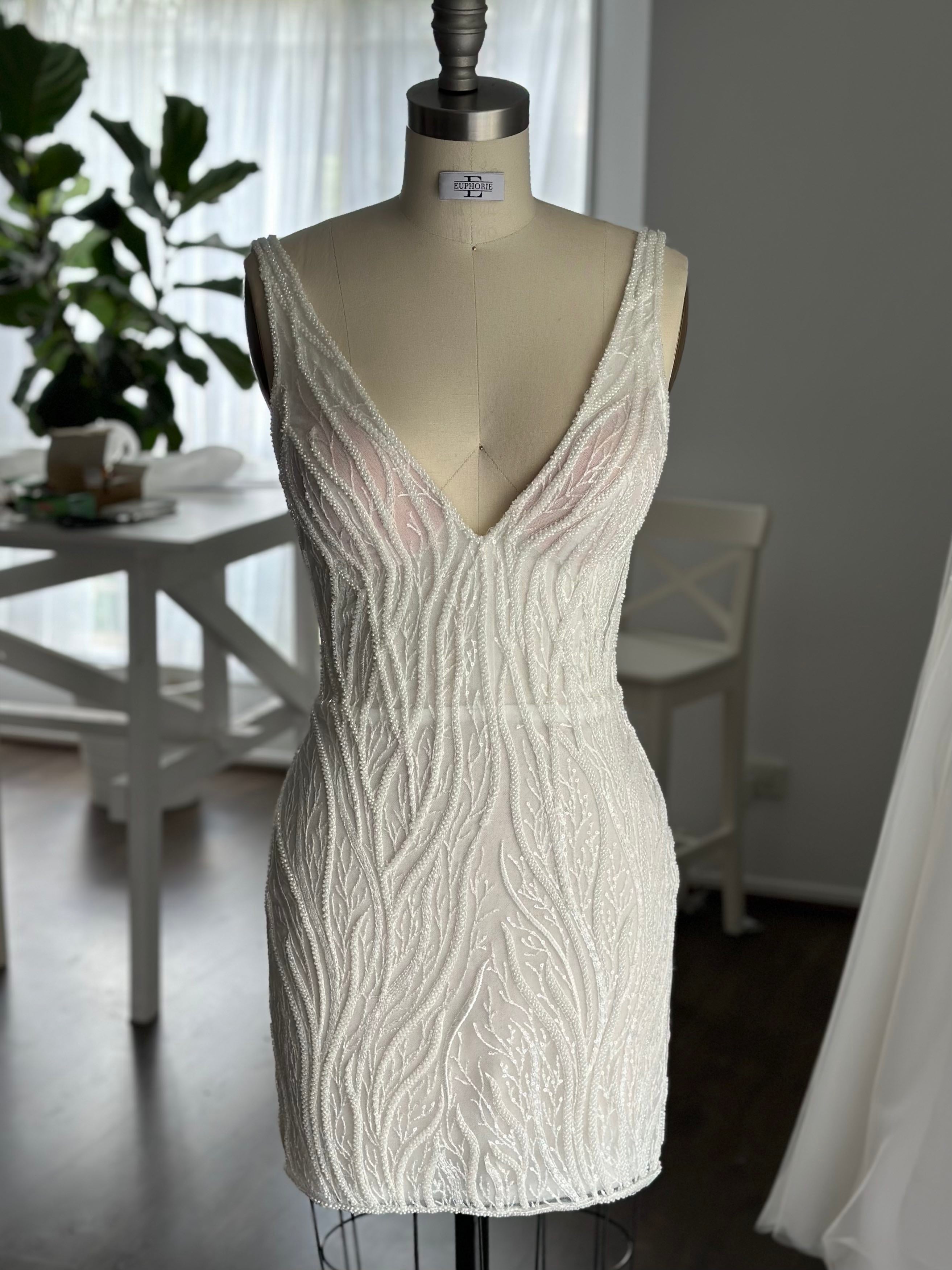 mini vine lace bridal gown on dress form