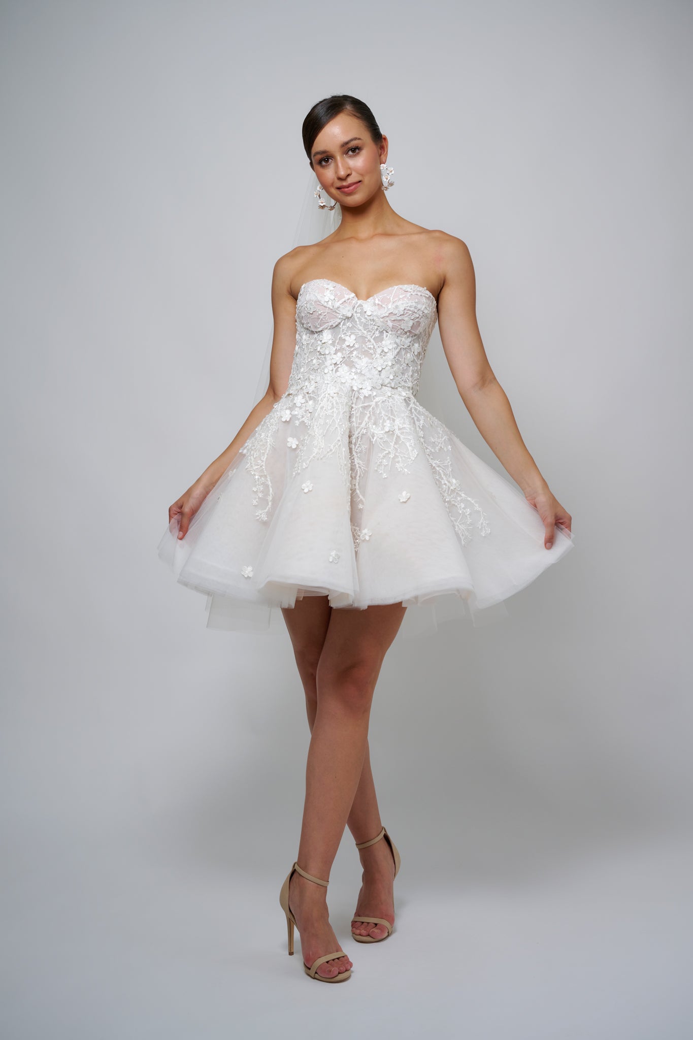model posing in floral lace mini wedding dress