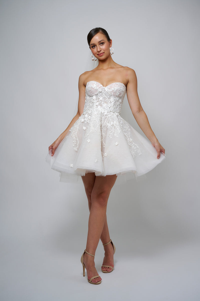 model posing in floral lace mini wedding dress