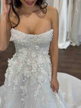 smiling bride wearing strapless wedding gown with pearl detailed bodice