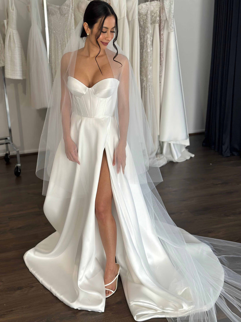 strapless wedding dress and white heels worn by bride with veil in her hair