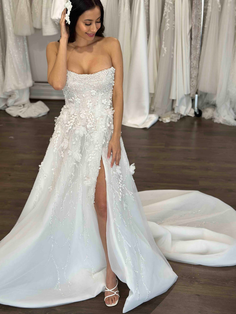 wedding dress with high split and pearls layered over beaded crystal lace
