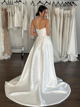 white flowing mikado strapless wedding dress on bride at studio